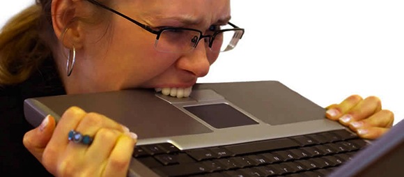 Woman biting computer